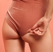 woman's butt in velvet leotard