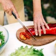 person cutting roasted pepper with chef's knives