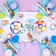 easter tabletop with eggs, flowers, and sugar cookies