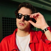 stylish man in red jacket with tortoiseshell sunglasses