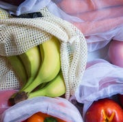 apples orange bananas in reusable produce bags
