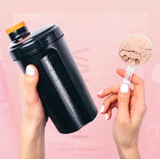 black shaker bottle and scoop of chocolate protein powder